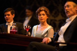 Gerald (Ethan Wilcox) and Sheila (Kiki Bagger) sit among Birling family patriarch Arthur (James Carpenter) in "An Inspector Calls." (Stanford Rep photo)